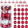 A collection of red and white Christmas baubles in a clear plastic container and arranged around it. Produktbild-Vorschau