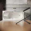 A top-down view of a white bathtub with a glass shower enclosure, set against a textured wall and wooden floor. Produktbild-Vorschau