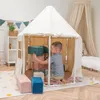 A young boy plays inside a cream-colored tent, building with colorful blocks. Produktbild-Vorschau