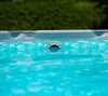 A close-up view of the edge of a swimming pool, showing the water and a part of the pool's structure. Produktbild-Vorschau