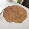 A round placemat with a wood grain pattern is placed on a marble-patterned table. Produktbild-Vorschau
