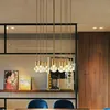A modern dining room with a chandelier hanging over a table. Produktbild-Vorschau
