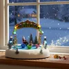 A Christmas-themed animated musical display sits on a windowsill during a snowy evening. Náhled obrázku produktu