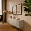 A modern living room with a wall-mounted TV lowboard, artwork, and a floor lamp. Náhľad obrázku produktu