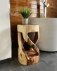 A wooden stool with a plant on top, placed next to a bathtub in a bathroom with wooden walls. Anteprima dell’immagine prodotto
