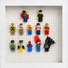 A collection of Lego minifigures displayed in a white frame on a white Lego baseplate. Produktbild-Vorschau