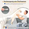 A man playing with a dog on a couch covered with a protective blanket. Náhled obrázku produktu