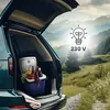 A mini refrigerator filled with drinks and fruit is placed in the open trunk of a car, with a scenic mountain landscape in the background. Náhled obrázku produktu