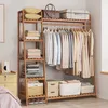 A wooden clothing rack with shelves and hanging clothes, in a room setting. Voir les images du produit