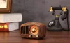 A vintage-style radio sits on a wooden table, with books and an old-fashioned telephone in the background. Produktbild-Vorschau