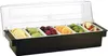 A black condiment dispenser with six clear plastic inserts filled with various fruits and garnishes, including lemon slices, lime slices, cherries, orange slices, grapes, and apple slices. A clear plastic lid is open and propped up. Produktbild-Vorschau