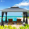 A gazebo with black curtains stands by a swimming pool with lounge chairs in front of it, overlooking the ocean. Voir les images du produit