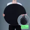 A person holds a large, round, black drying net. A smaller inset image shows the net folded into a carrying bag. Produktbild-Vorschau