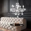 A luxurious crystal chandelier hangs above a plush tufted sofa in a modern living room. Anteprima dell’immagine prodotto