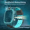 A teal smartwatch with a light blue strap is shown in a dark, starry environment, with a flashlight feature illuminated. Produktbild-Vorschau