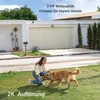A woman is playing with a dog in a grassy yard in front of a modern house with a garage door. Náhled obrázku produktu