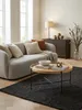 Design-Couchtisch 78x40 cm von oben fotografiert, zeigt die runde Eichenholzplatte mit erhöhtem Rand und die harmonische Anordnung im Wohnzimmer-Ambiente._#sku_BARWL6.493# Produktbild-Vorschau