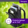 A black Targus backpack with a laptop and magazines inside, set against a blurred green leafy background. Náhľad obrázku produktu