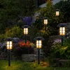 Solar garden lights illuminating a garden at dusk. Produktbild-Vorschau