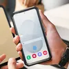 A person is holding a smartphone in a protective case. Náhled obrázku produktu