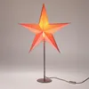 A decorative star-shaped lamp with LED lights, standing on a dark metal base. Náhled obrázku produktu