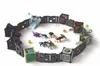 A circular arena made of modular gray blocks, with several small toy creatures inside. Some of the blocks are cages, and there are also some small balls and other accessories scattered around. Produktbild-Vorschau