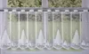 A white lace curtain with a Christmas tree and snowflake pattern hanging in a window. Produktbild-Vorschau