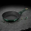 A green frying pan with a gold accent on the handle, placed on a dark, textured surface with scattered green gems and small rocks. Anteprima dell’immagine prodotto