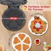 A waffle maker and various waffles are displayed on a wooden surface. Produktbild-Vorschau