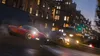 Two sports cars racing on a wet city street at dusk. Produktbild-Vorschau
