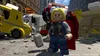A LEGO minifigure of Thor stands in a city street amidst debris and damaged vehicles. Podgląd zdjęcia produktu