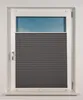 A window with a dark gray pleated blind partially covering it. Produktbild-Vorschau