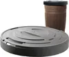 A brown barrel-shaped water tank with a black lid is shown in the background, and a large gray circular lid is in the foreground. Produktbild-Vorschau