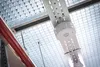 A close-up view of a suspended LED light fixture and red piping against a grid-like ceiling. Produktbild-Vorschau