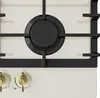 A close-up view of a cream-colored gas hob with black grates and burners, and gold control knobs. Náhľad obrázku produktu