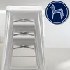 A close-up of a silver metal bar stool, with a circular icon indicating stackability. Náhľad obrázku produktu