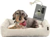 A dachshund dog wearing a bandana lies in a beige corduroy dog bed. A tag with a dog waste bag dispenser and roll is attached to the bed.