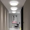 A modern hallway with three ceiling lights, a painting, and a chair. Podgląd zdjęcia produktu