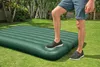A person is stepping onto an inflatable mattress on a grassy lawn. Produktbild-Vorschau
