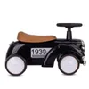 A black retro-style ride-on car for children, shown from the side against a white background. Náhled obrázku produktu