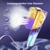 A close-up shot of a portable steam iron, emitting steam. Produktbild-Vorschau