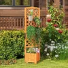 A wooden planter box with a trellis is placed in a garden setting, surrounded by lush greenery and flowers. Podgląd zdjęcia produktu