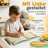 Junge schaut konzentriert in ein aufgeschlagenes Freundebuch Kindergarten Produktbild-Vorschau