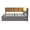 A side view of a dark gray upholstered bed frame with a built-in wooden bookshelf headboard and integrated LED lighting. Náhled obrázku produktu