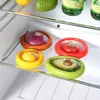 A close-up view of four food storage containers, each holding a piece of produce, placed on a shelf inside a refrigerator. Produktbild-Vorschau