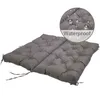 A gray tufted cushion with ties, shown on a white background. A circular inset highlights water droplets on the cushion's surface, with the word "Waterproof" below. Produktbild-Vorschau