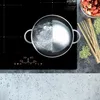 A split image showing a pot of boiling water on an induction cooktop and uncooked pasta and ingredients. Voir les images du produit