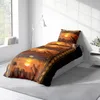 A bed with a duvet cover featuring an African safari scene with elephants and giraffes at sunset. Produktbild-Vorschau