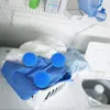 Laundry room setting with a basket of clothes and three blue laundry balls. Anteprima dell’immagine prodotto