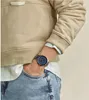 A person wearing a watch, hoodie, and jeans. Produktbild-Vorschau